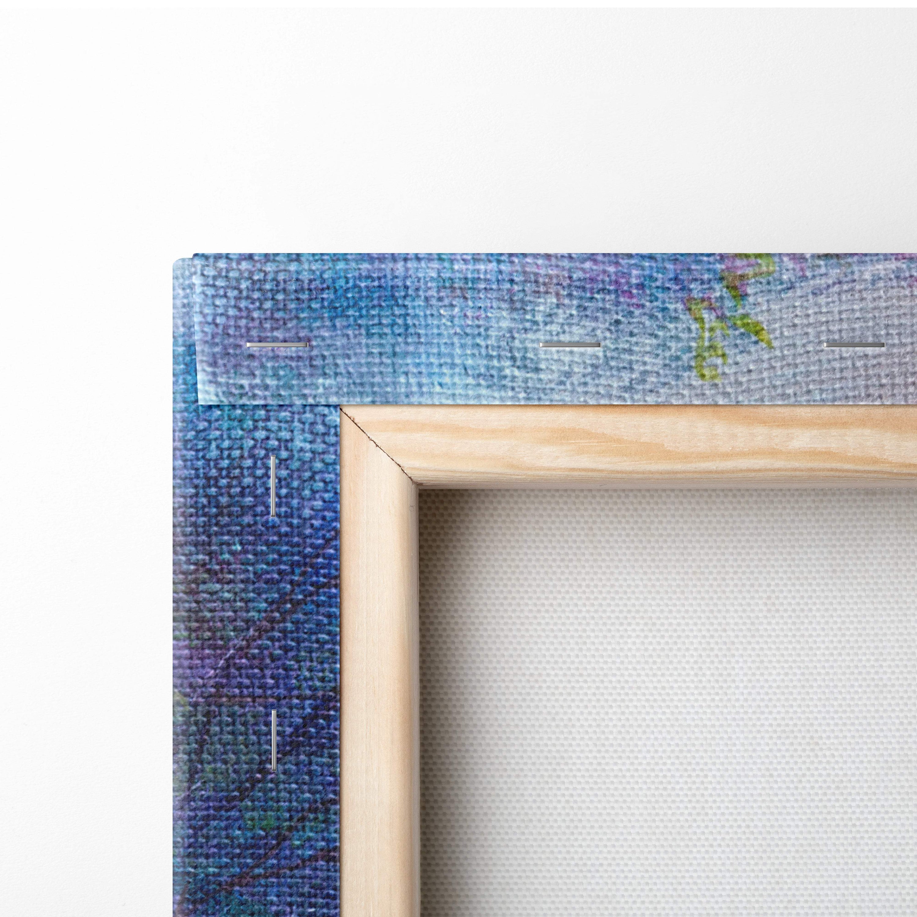 A wooden-framed canvas print featuring a textured abstract blue and purple watercolor design for wall art