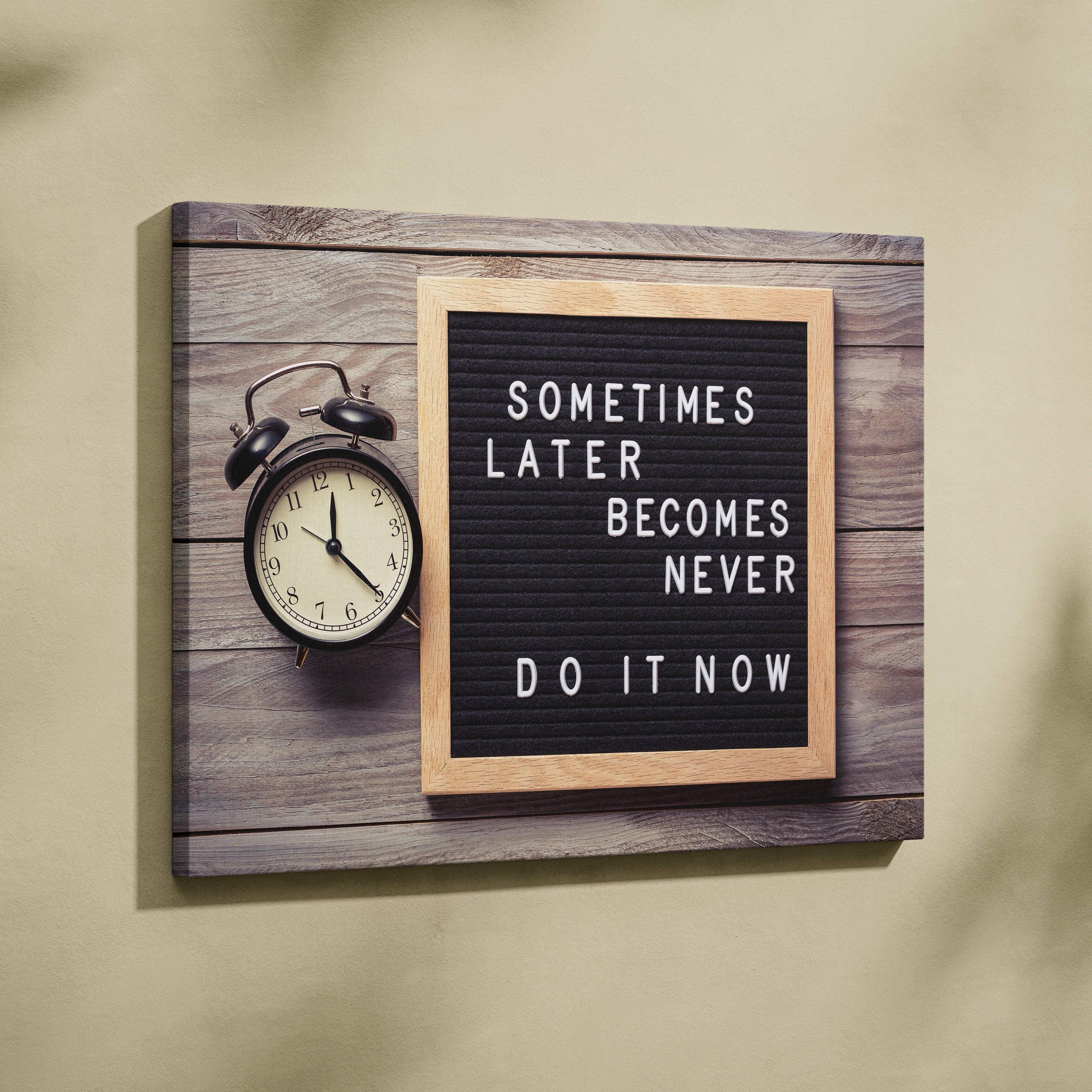 Motivational office canvas wall art with black letterboard light wood frame displaying sometimes later becomes never do it now quote