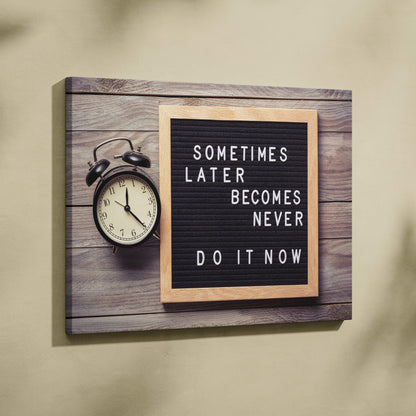 Motivational office canvas wall art with black letterboard light wood frame displaying sometimes later becomes never do it now quote