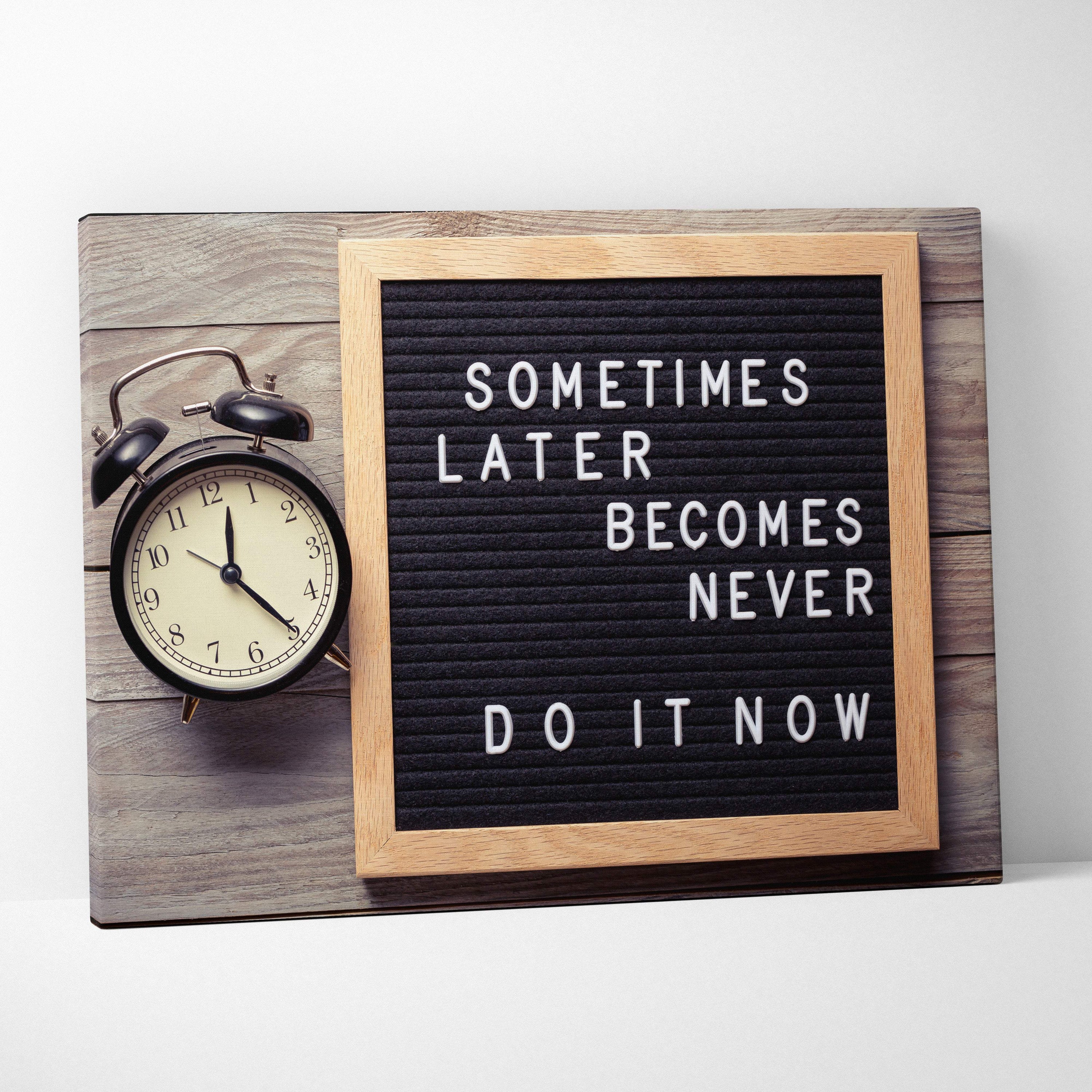 Motivational office canvas wall art with white typography on black letterboard framed in light wood for inspirational decor