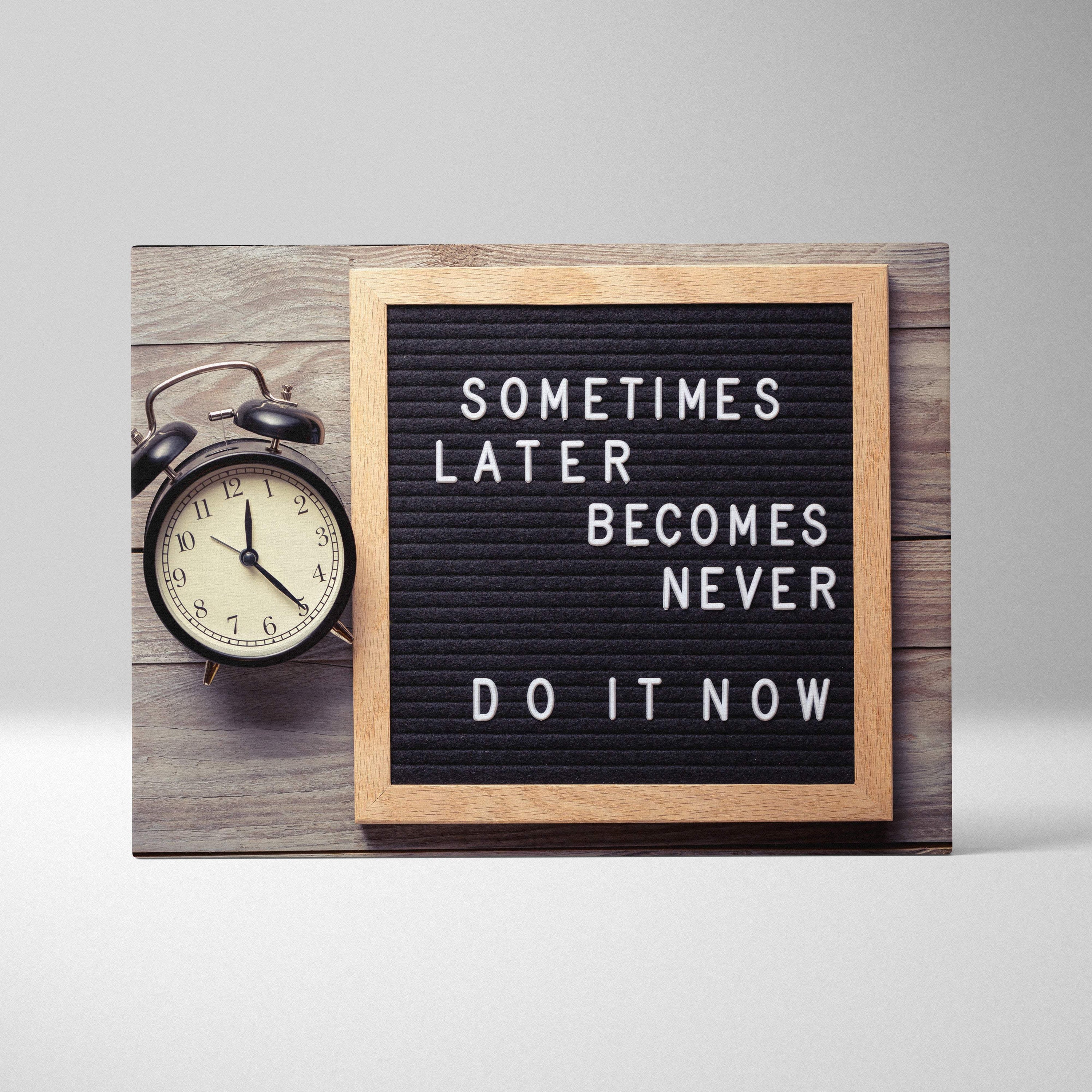 Motivational office canvas wall art with a black letterboard and white letters in a light wood frame with inspirational quote