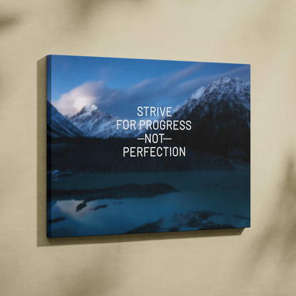 Motivational mountain canvas wall art featuring blue nature landscape with strive for progress not perfection text quote