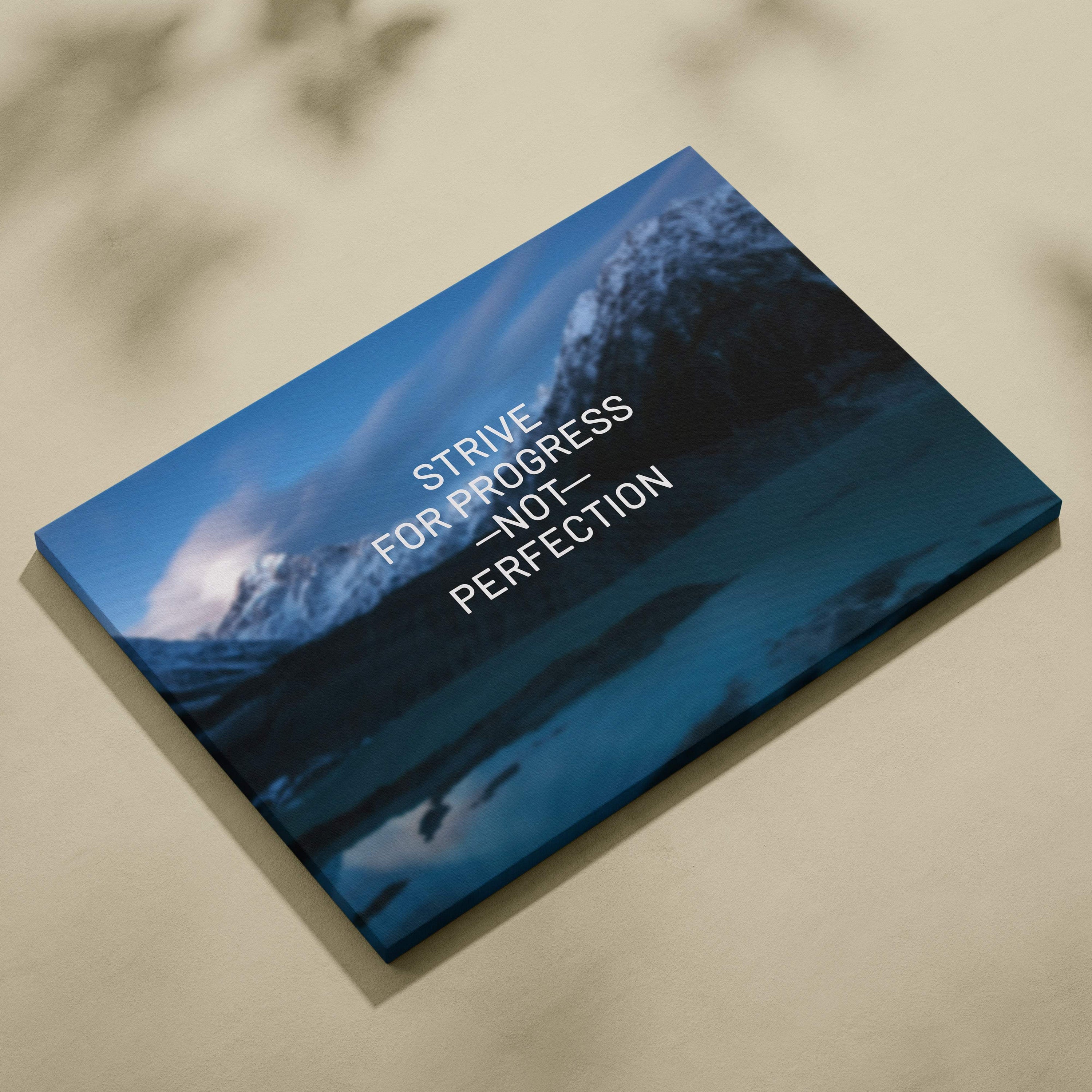Motivational mountain canvas wall art with blue landscape and strive for progress not perfection quote print