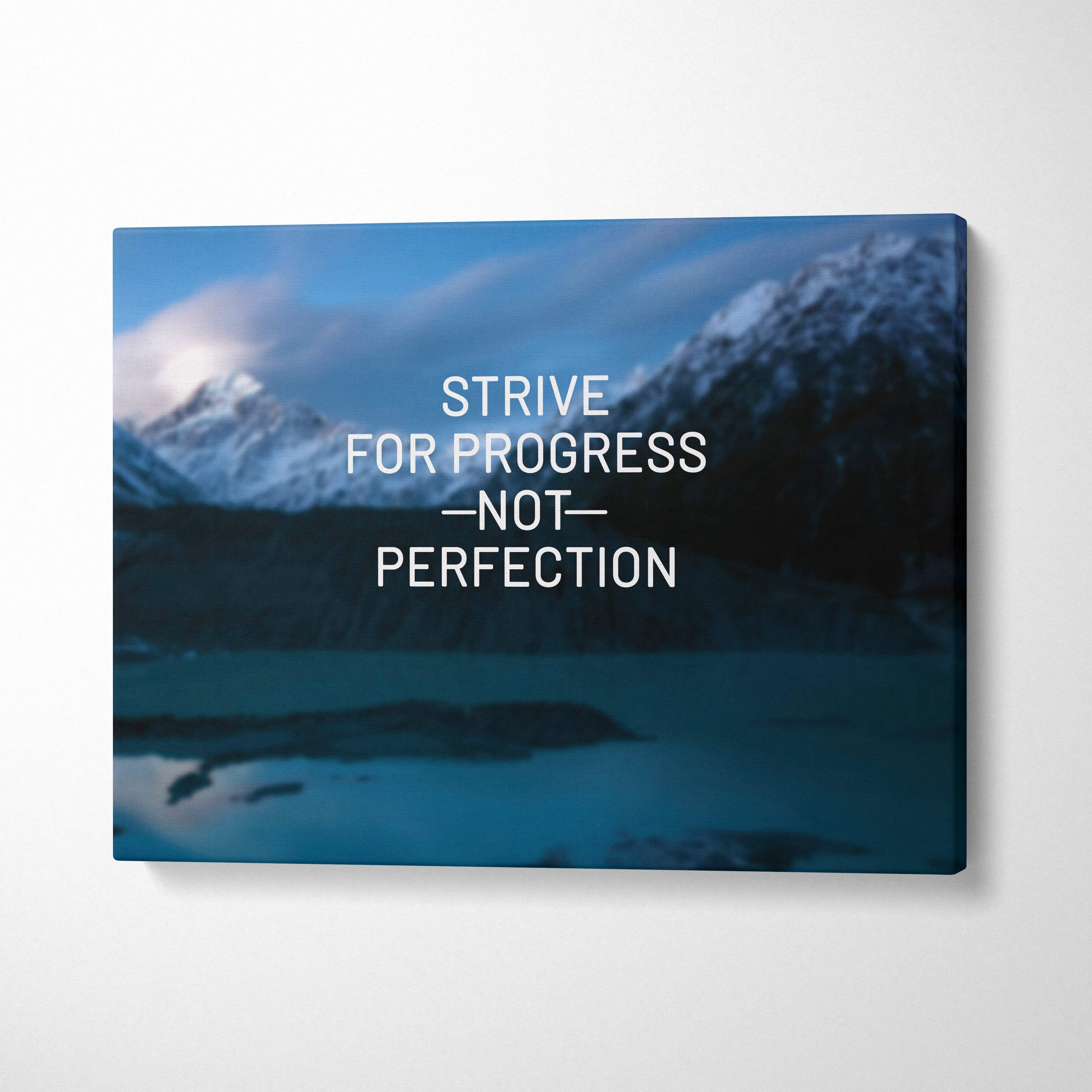 Blue mountain landscape canvas wall art featuring white motivational text strive for progress not perfection