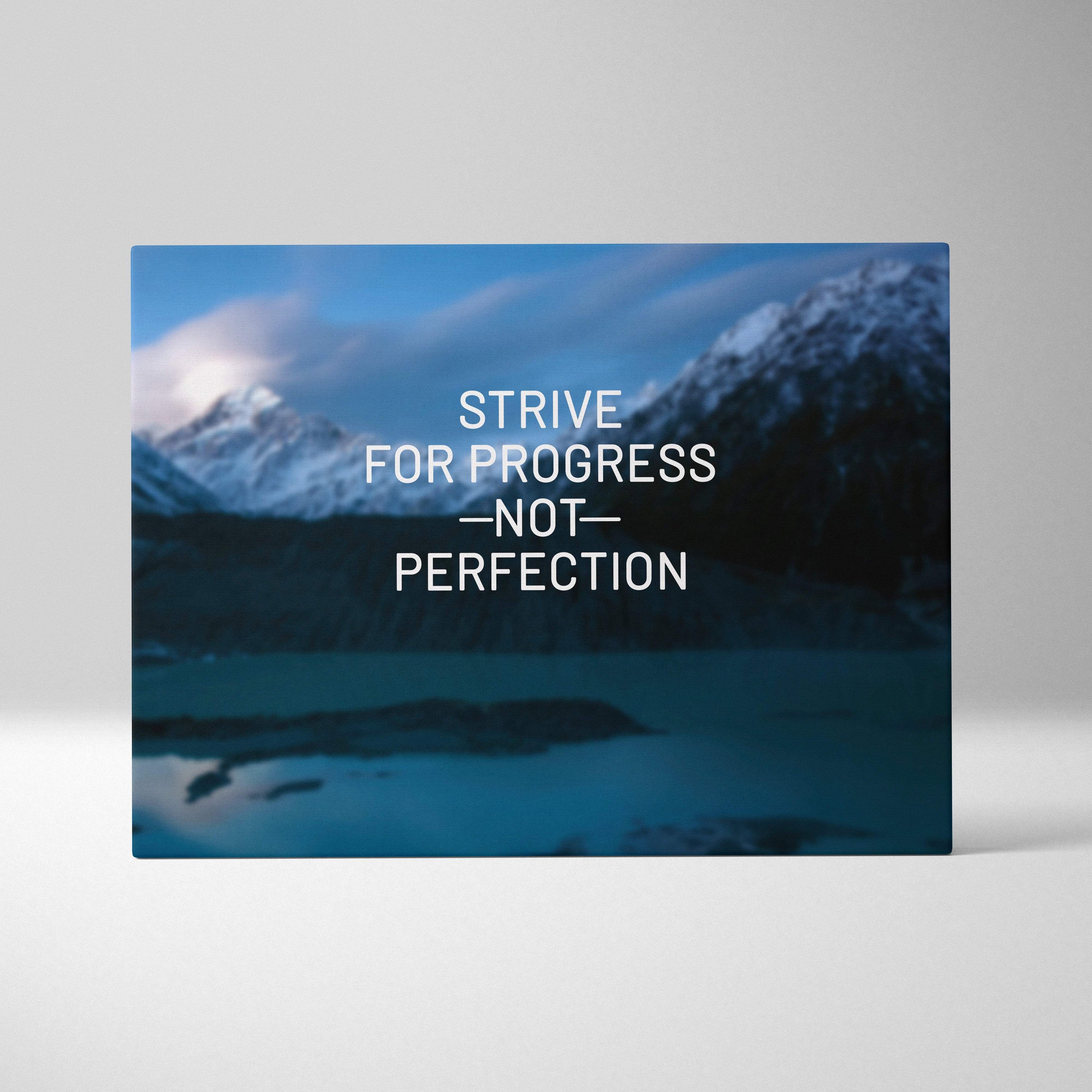 Rectangular canvas wall art featuring a blue serene mountain lake with snow-capped peaks and strive for progress text