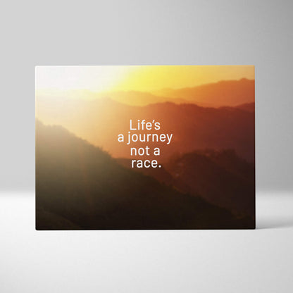 Motivational mountain sunset canvas wall art with warm orange tones and inspirational life’s a journey not a race quote