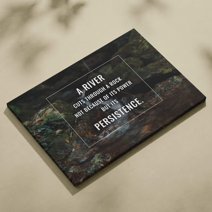 Motivational river canvas wall art with a dark green textured rock and water image featuring a persistence quote print