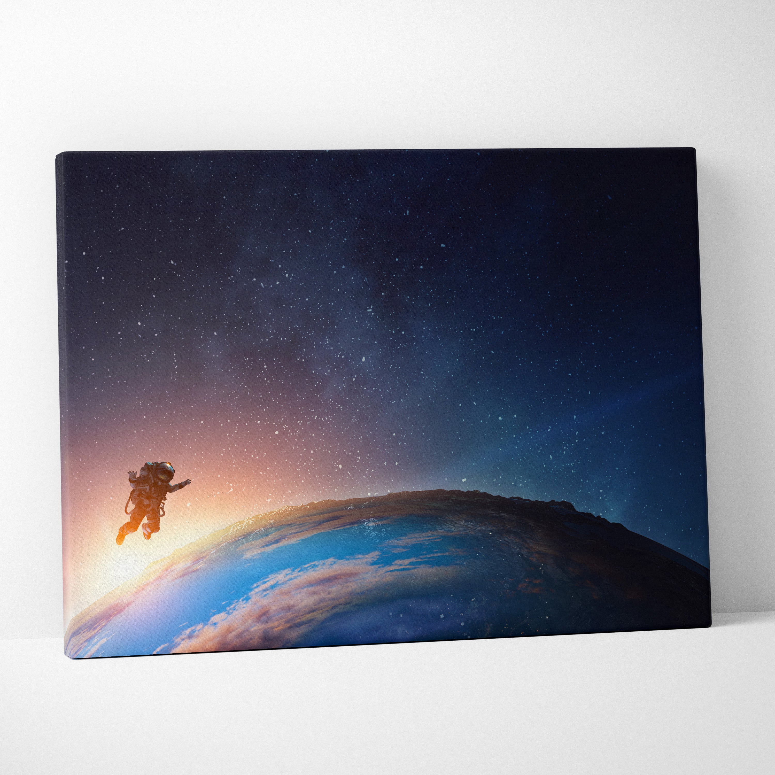 Astronaut earth orbit canvas wall art print featuring an astronaut floating in space with blue starry sky and orange earth horizon