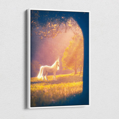White-framed canvas print of a luminous white unicorn standing in a golden meadow under warm sunlight