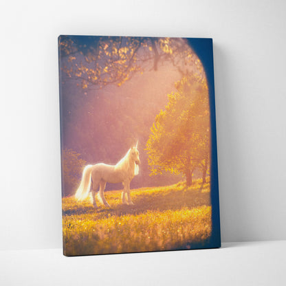 A rectangular canvas print of a white unicorn standing in a golden meadow with sunlight in a sunlit forest