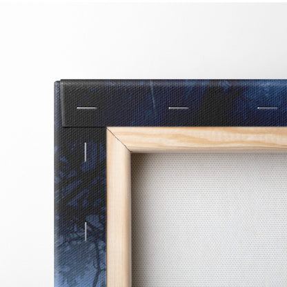 Light-colored wooden frame holding dark blue canvas with visible stitching featuring haunted forest apparition wall art