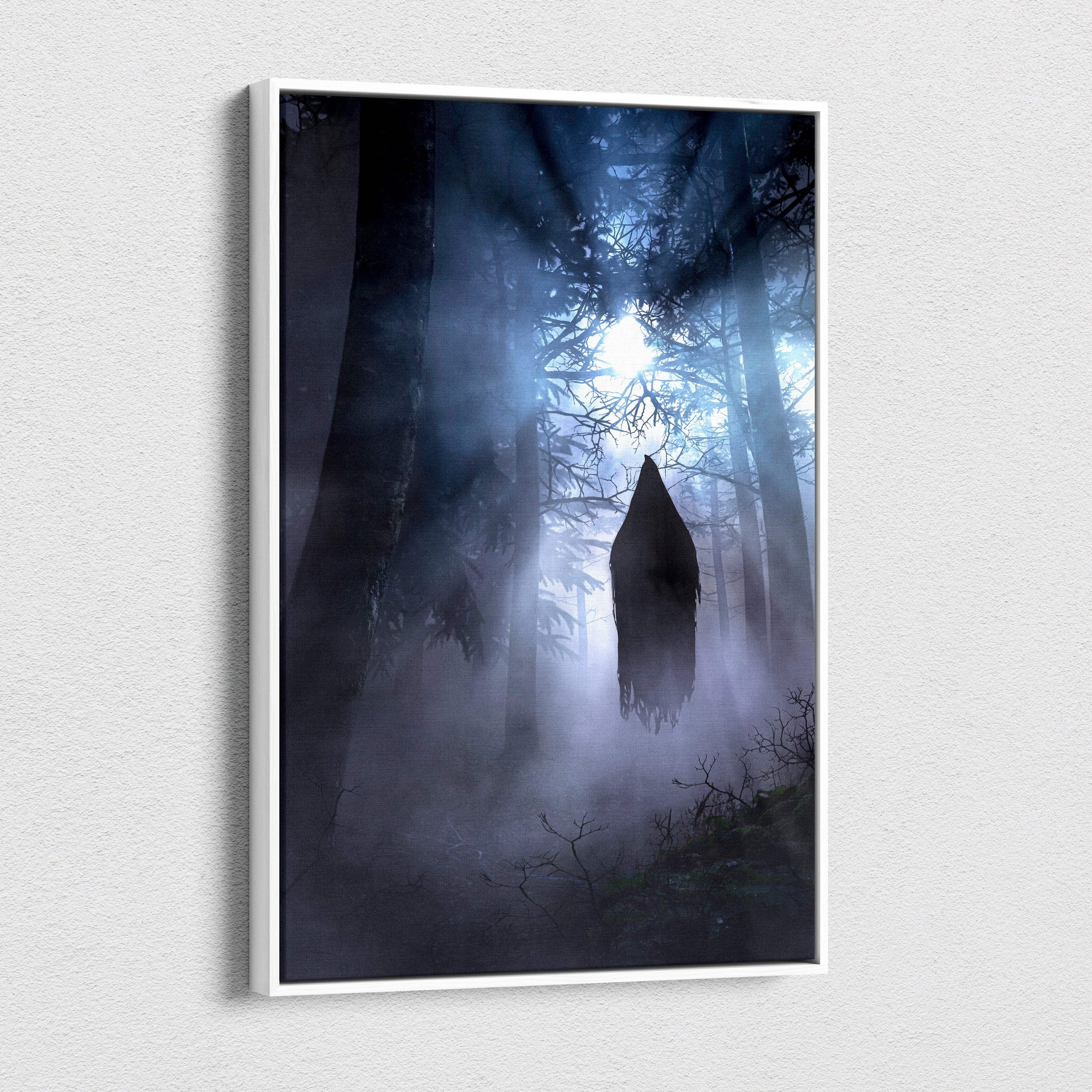 A framed canvas print showing a floating hooded ghost silhouette in a misty forest with blue light beams