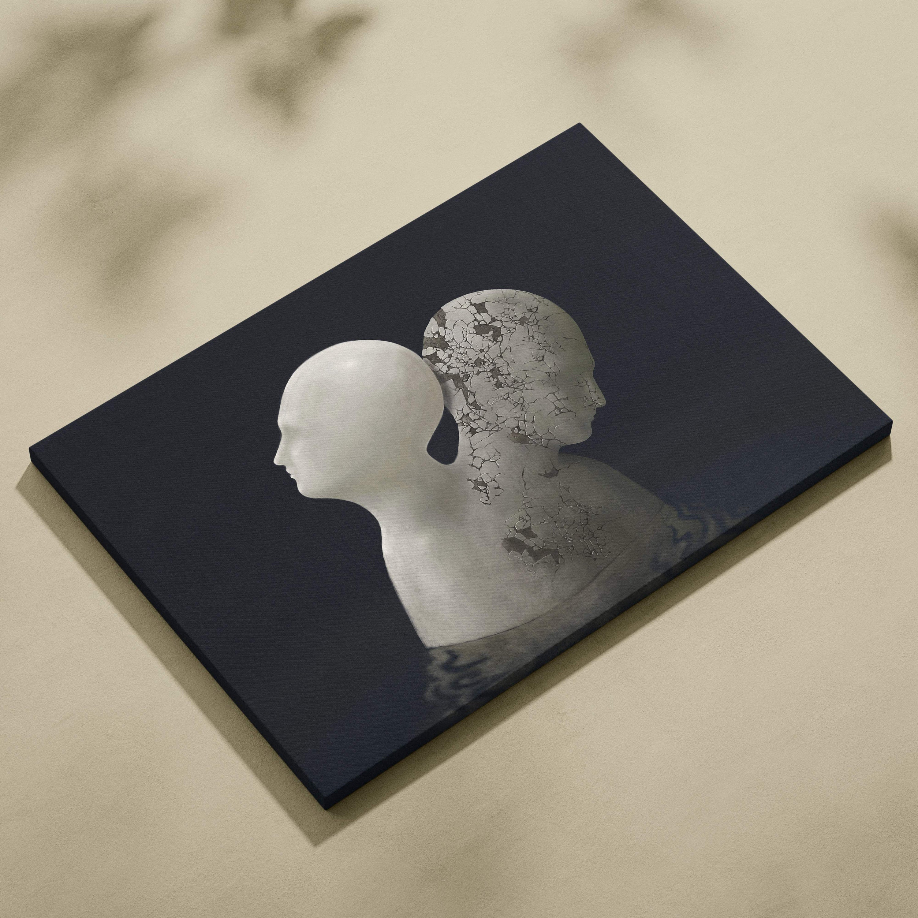 Black canvas print featuring a minimalist white silhouette overlapping a cracked silver face for moody wall decor