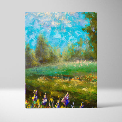 Green meadow landscape canvas print featuring lush green fields wildflowers in purple and yellow and bright blue sky