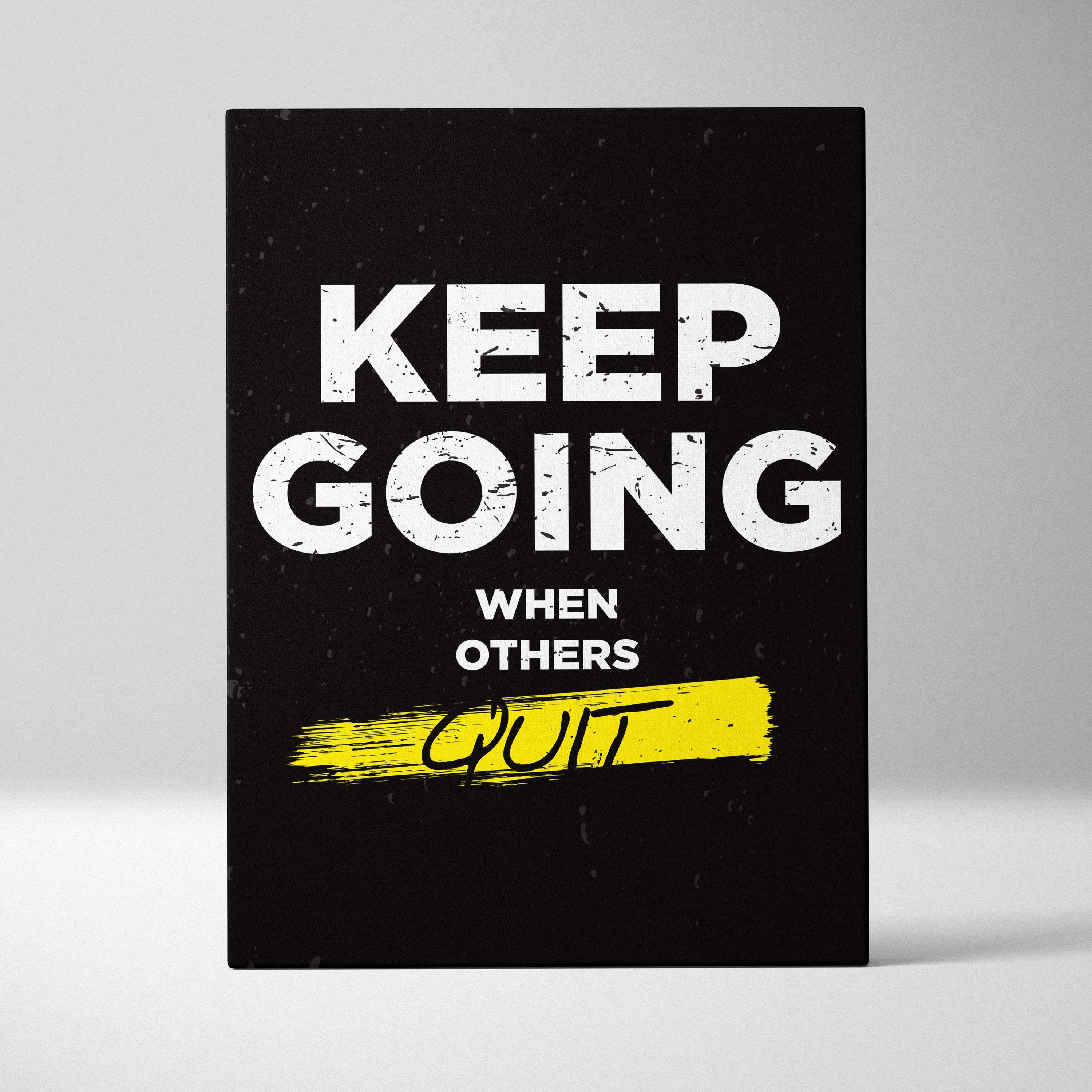 Black canvas print with bold white keep going when others quit phrase and yellow brushstroke for gym office or home decor
