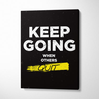 Black canvas print featuring keep going when others quit motivational phrase with yellow brushstroke accent for gym or office decor