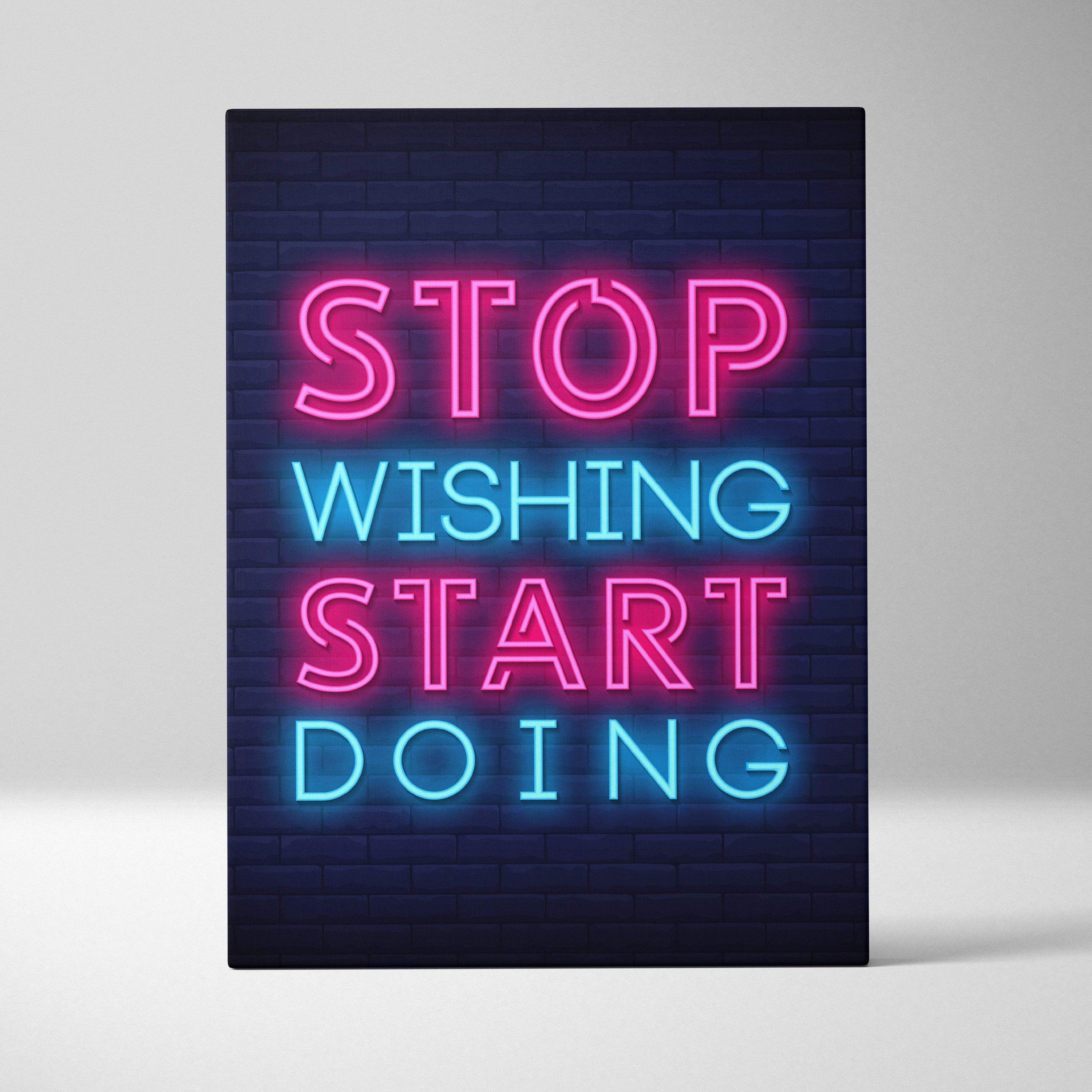 Stop wishing start doing motivational neon wall art canvas with pink and blue glowing letters on dark brick background