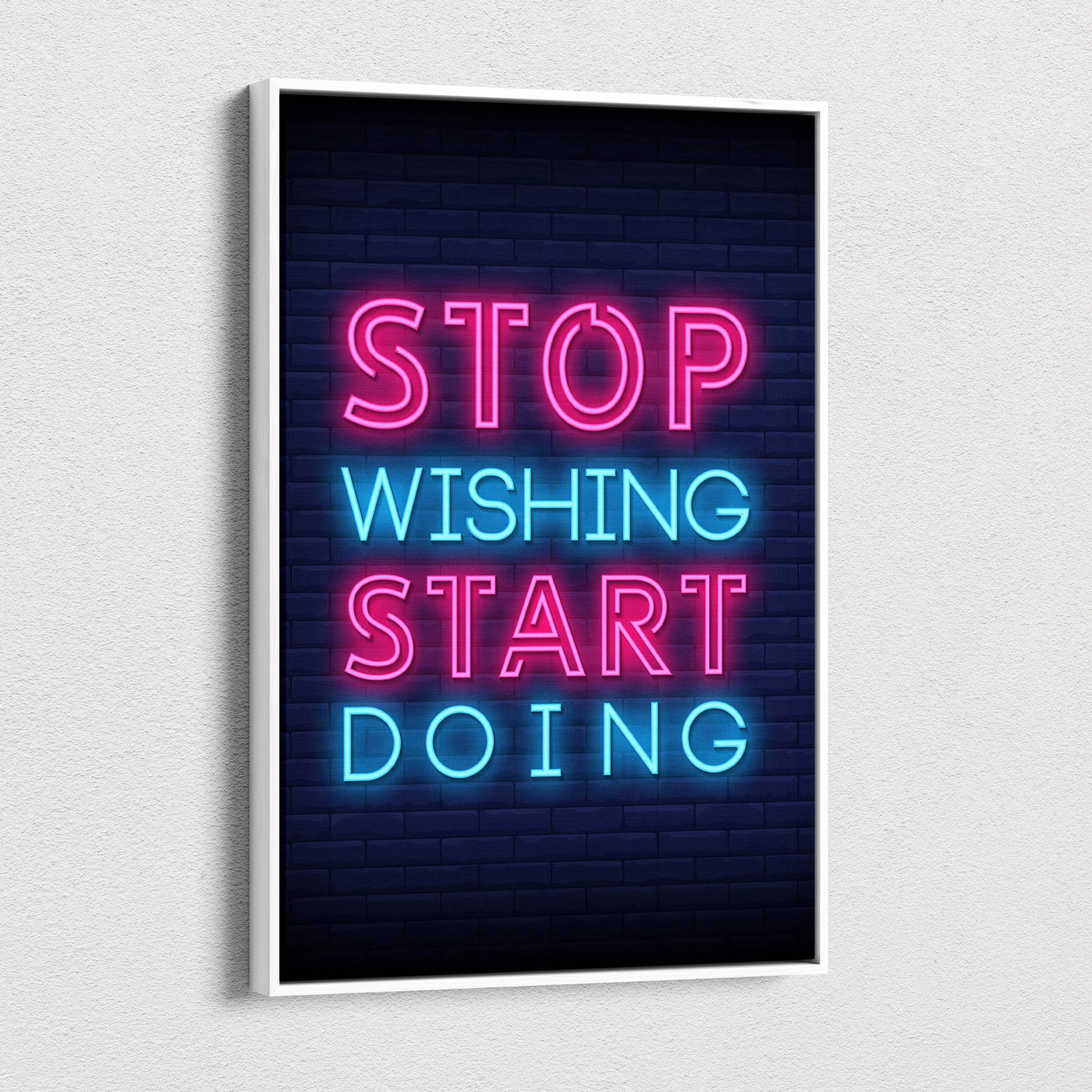 Stop wishing start doing motivational neon wall art print with pink and blue glowing letters on dark brick background