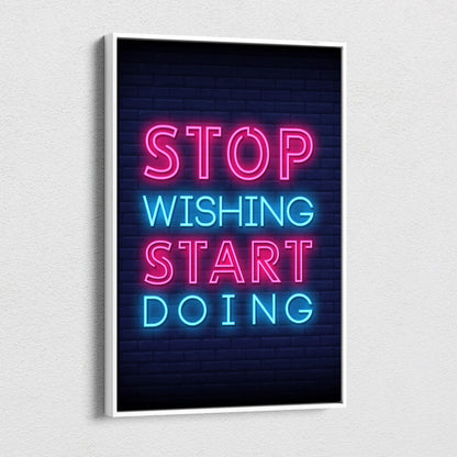 Stop wishing start doing motivational neon wall art print with pink and blue glowing letters on dark brick background