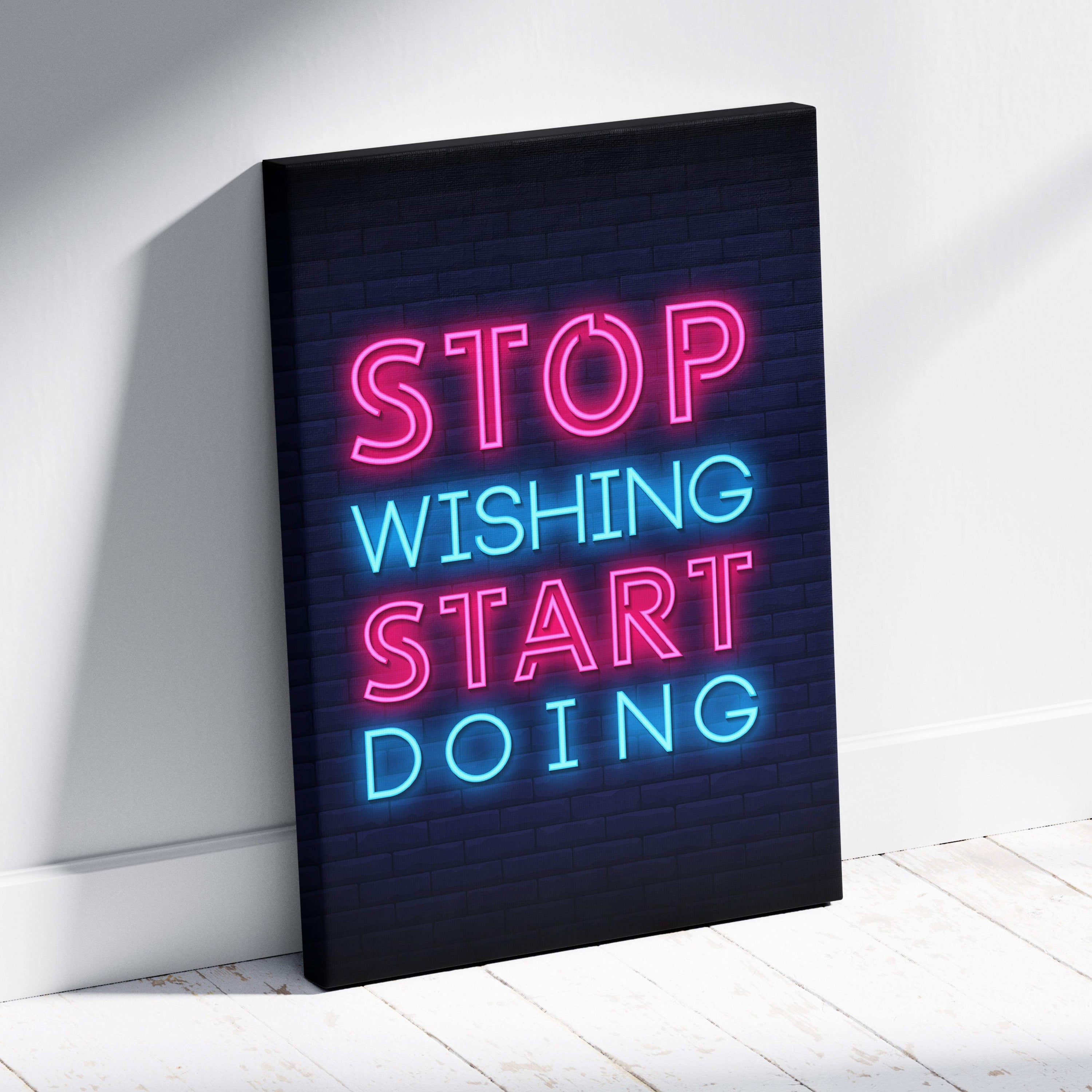 Stop wishing start doing motivational neon wall art print with vibrant pink and blue glowing letters on dark brick canvas