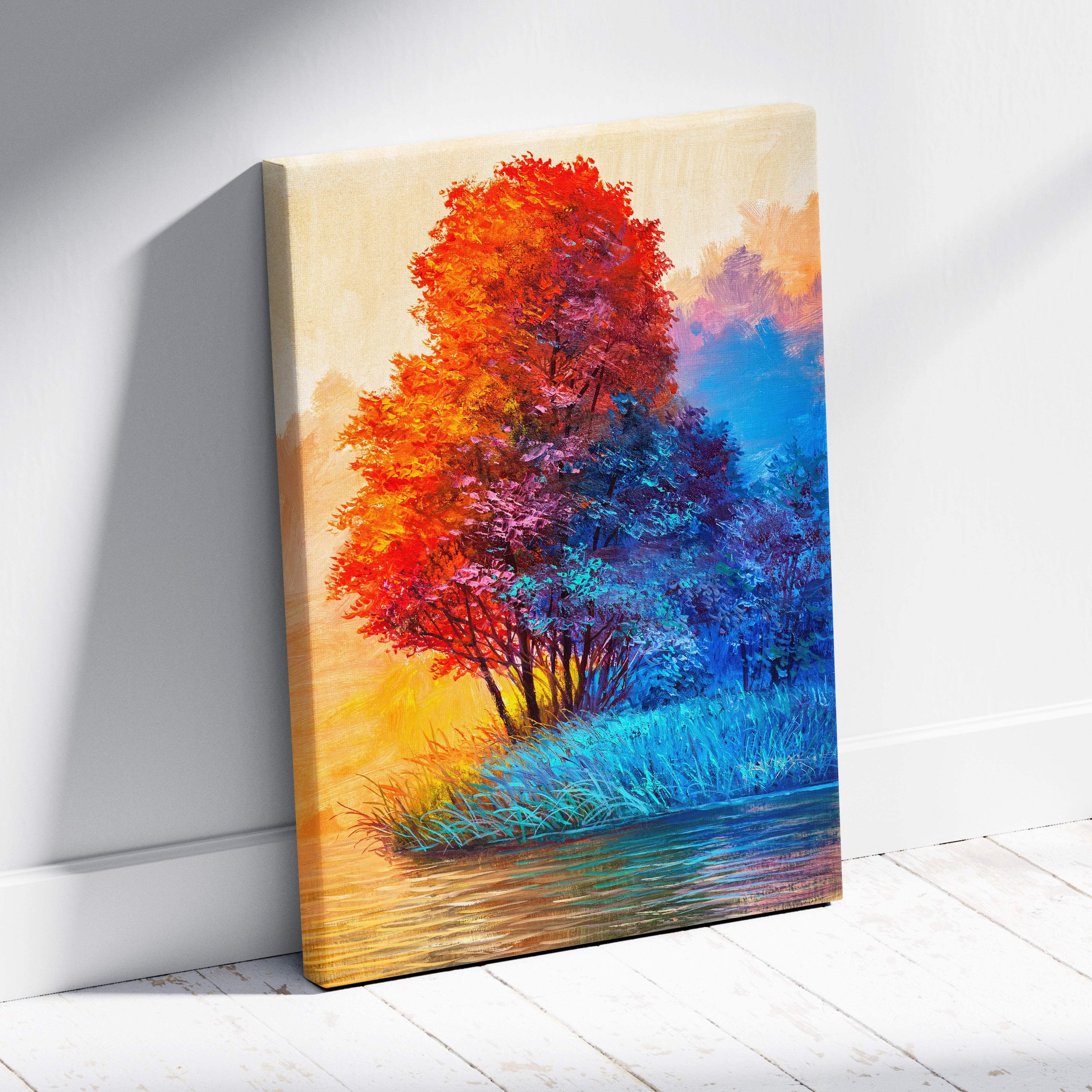 Vibrant colorful abstract tree landscape canvas print with fiery red orange leaves blue foliage and reflective water under golden sky