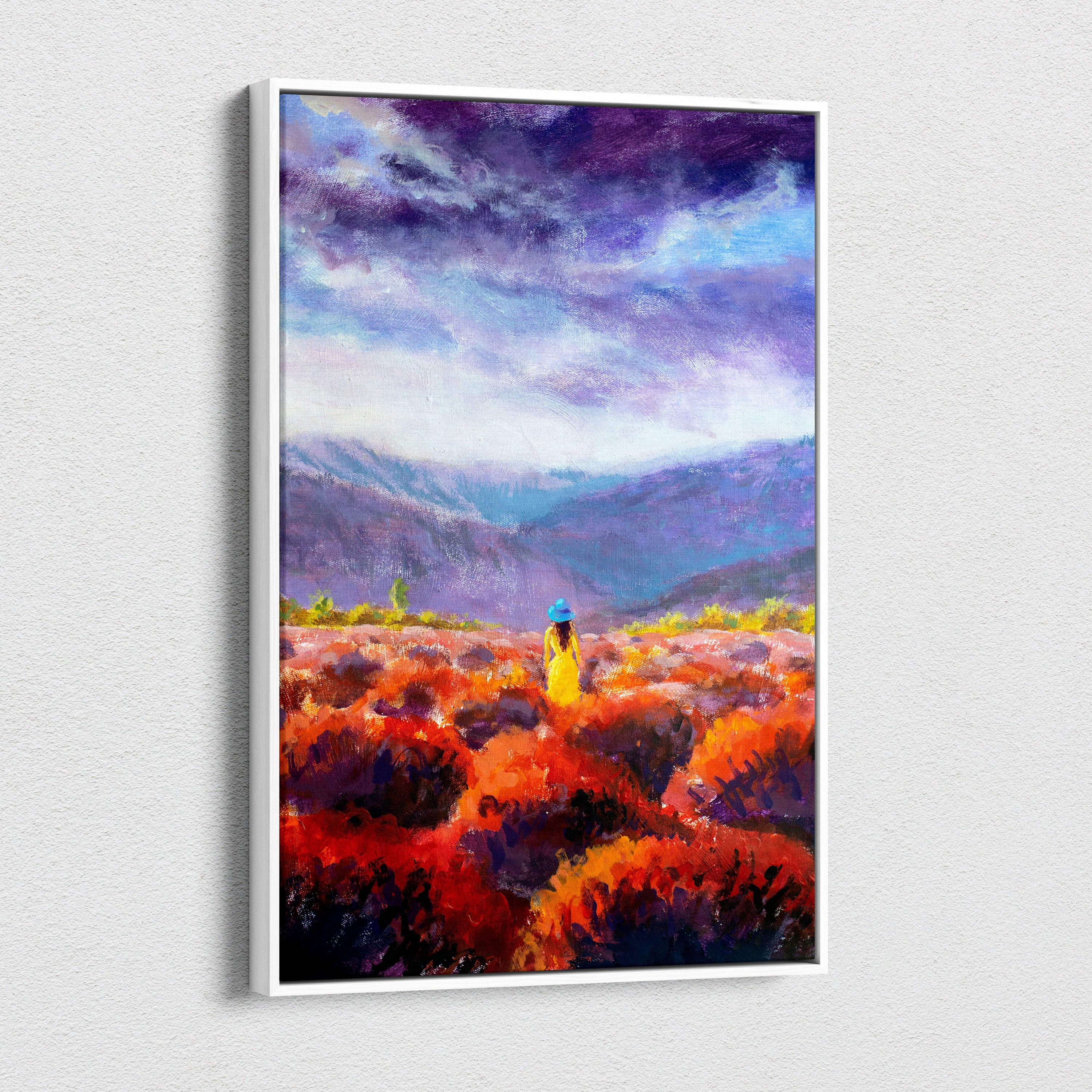 A framed canvas print of a lone woman in a yellow dress and blue hat among red orange flowers under a purple sky