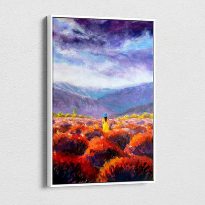 A framed canvas print of a lone woman in a yellow dress and blue hat among red orange flowers under a purple sky