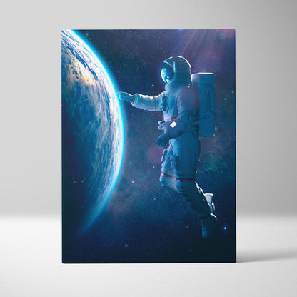 A rectangular canvas print of a floating astronaut near earth in a blue cosmic space scene wall decor