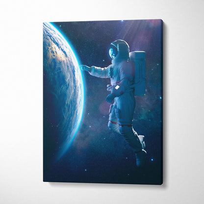 Canvas print of astronaut in white spacesuit with red accents floating near earth in blue cosmic space scene