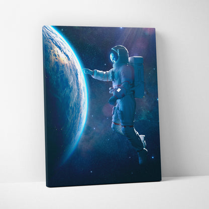 A canvas print of a floating astronaut near earth with blue and brown planet surface in a starry cosmic space scene