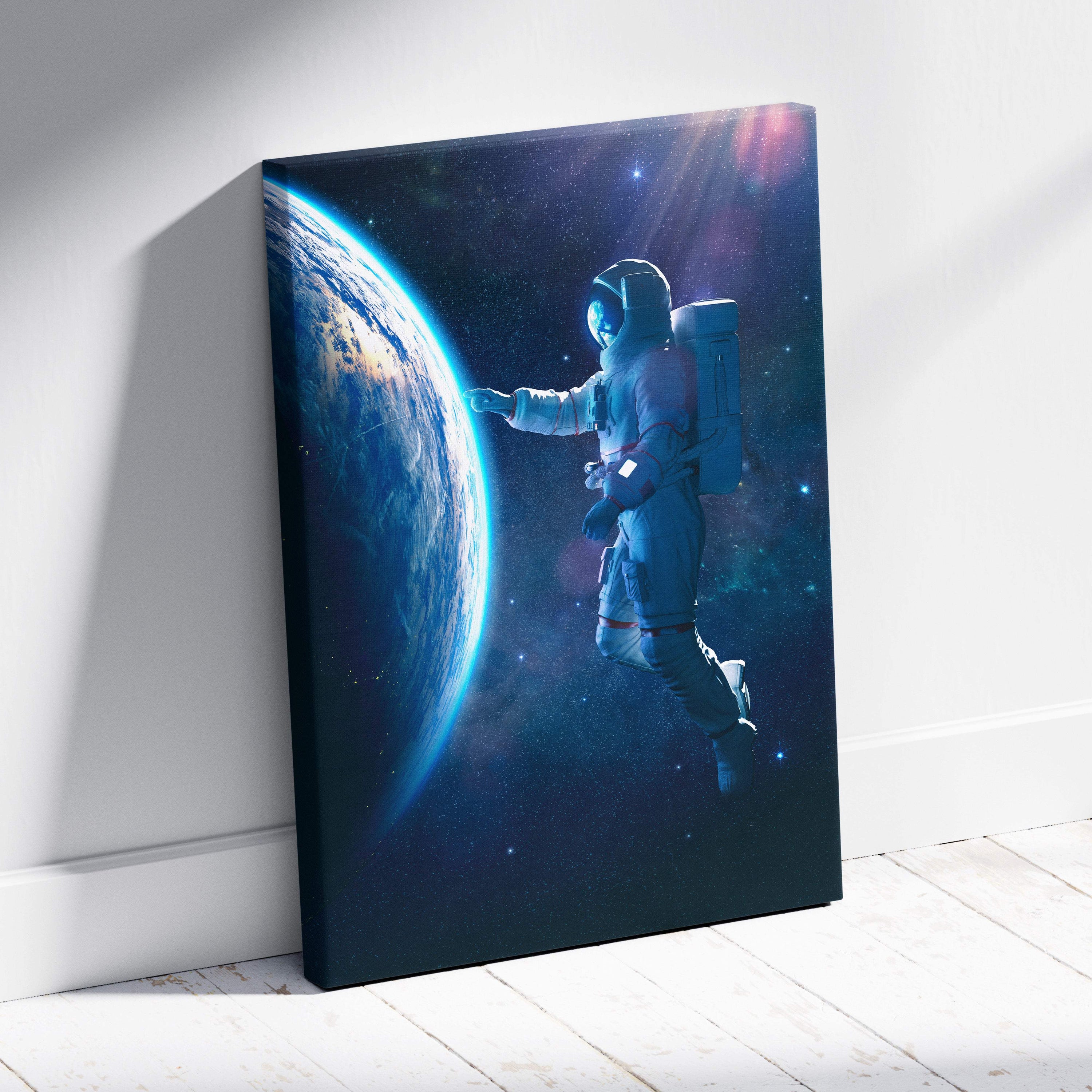 Rectangular canvas print of a floating astronaut near earth with blue cosmic space and starry galaxy background
