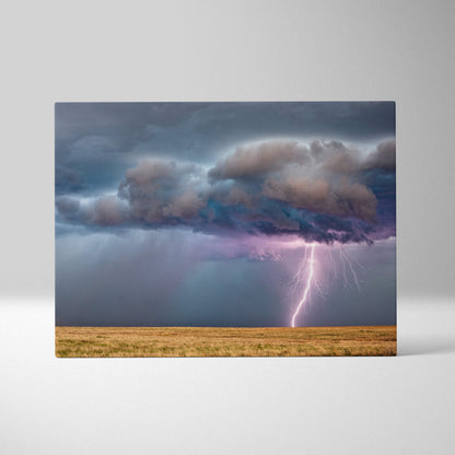 Lightning strike over prairie canvas art with moody blue storm clouds and a purple flash in dramatic minimal landscape