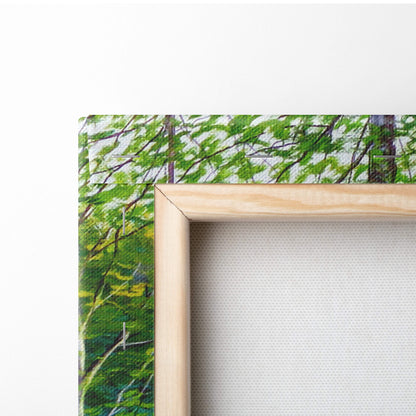 Light wood-framed canvas print featuring a vibrant green forest with detailed branches for nature wall art decor