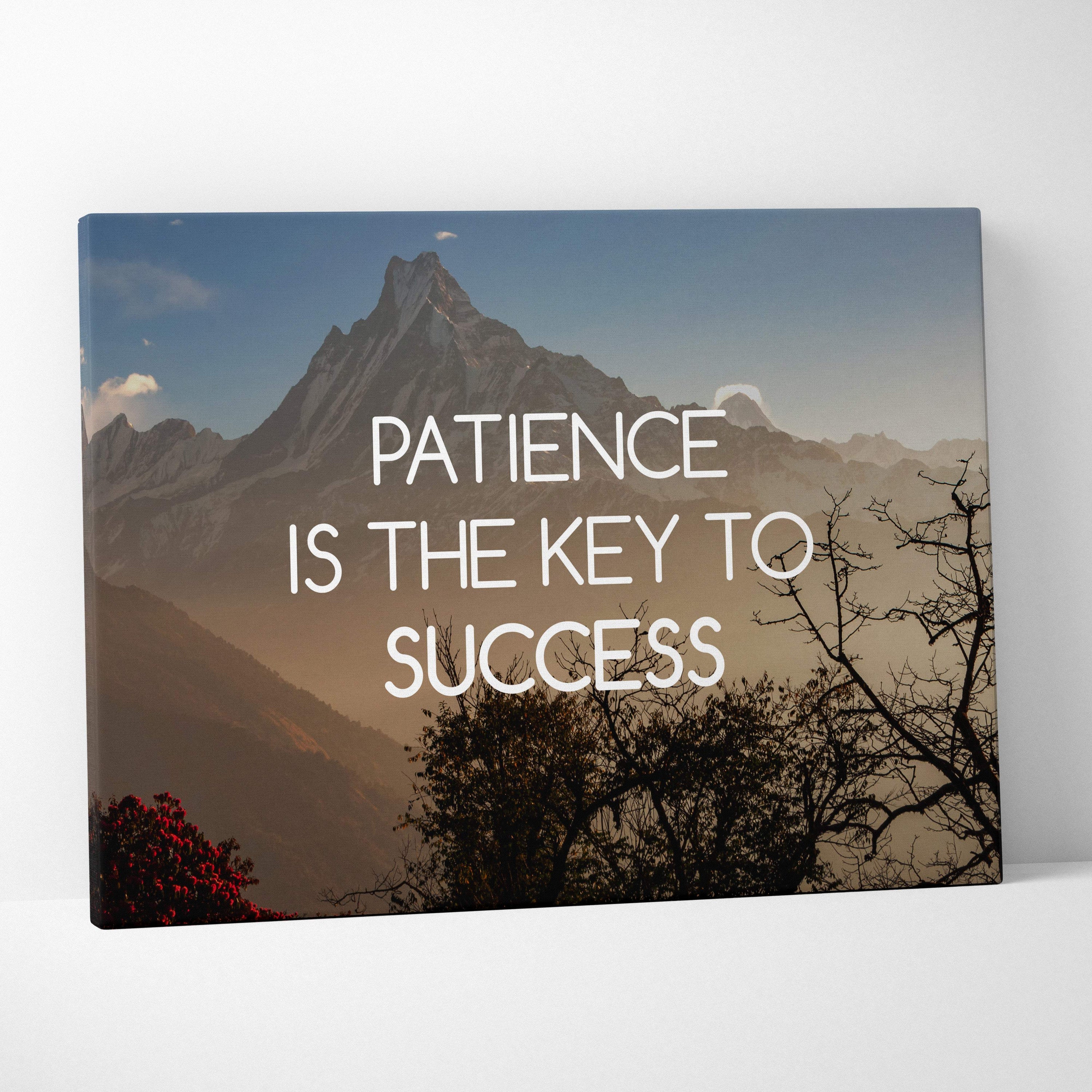 Rectangular canvas wall art featuring a mountain landscape with the phrase patience is the key to success in white text