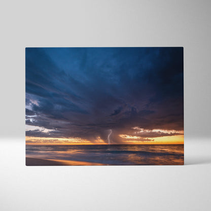 Rectangular canvas art featuring a stormy ocean sunset with deep blue clouds golden horizon and lightning over the sea