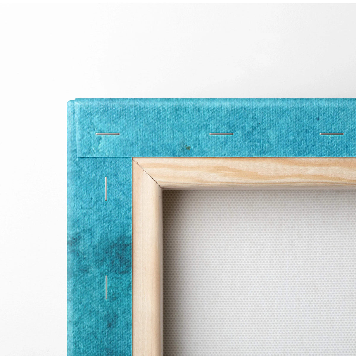 Teal felt-covered canvas frame with wood border on ocean wave art