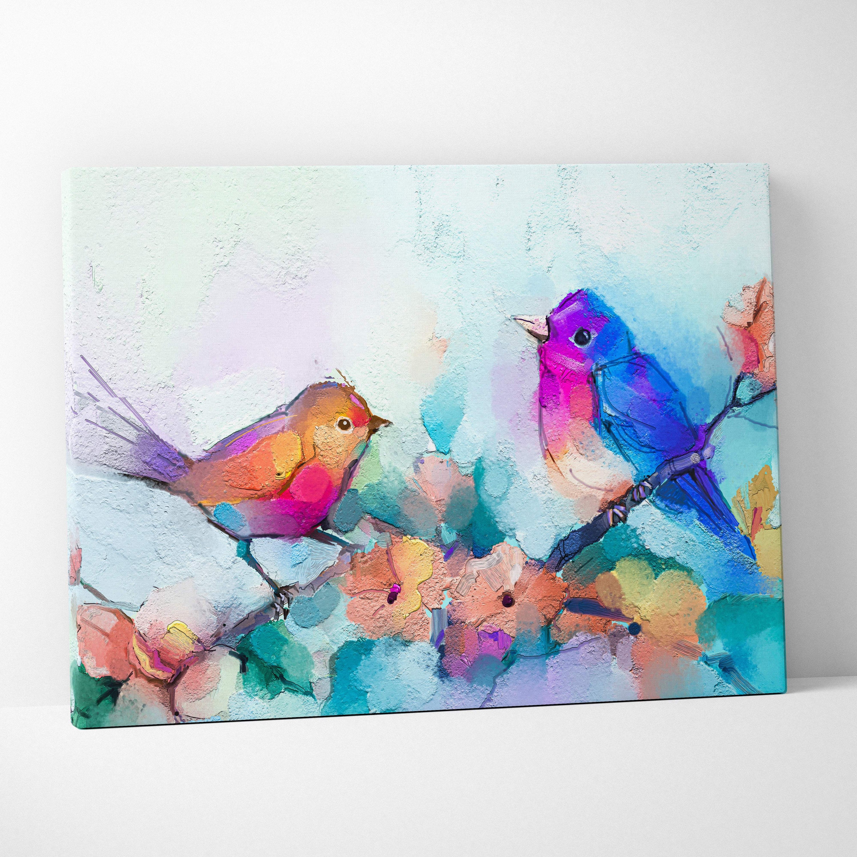 Vibrant pastel canvas wall art featuring textured brushstrokes of colorful birds on a blossom branch in pink and blue hues