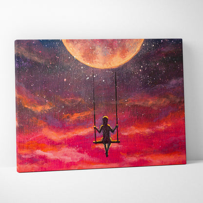 Vibrant canvas print of a girl silhouette on swing under large orange moon with swirling red pink and purple clouds