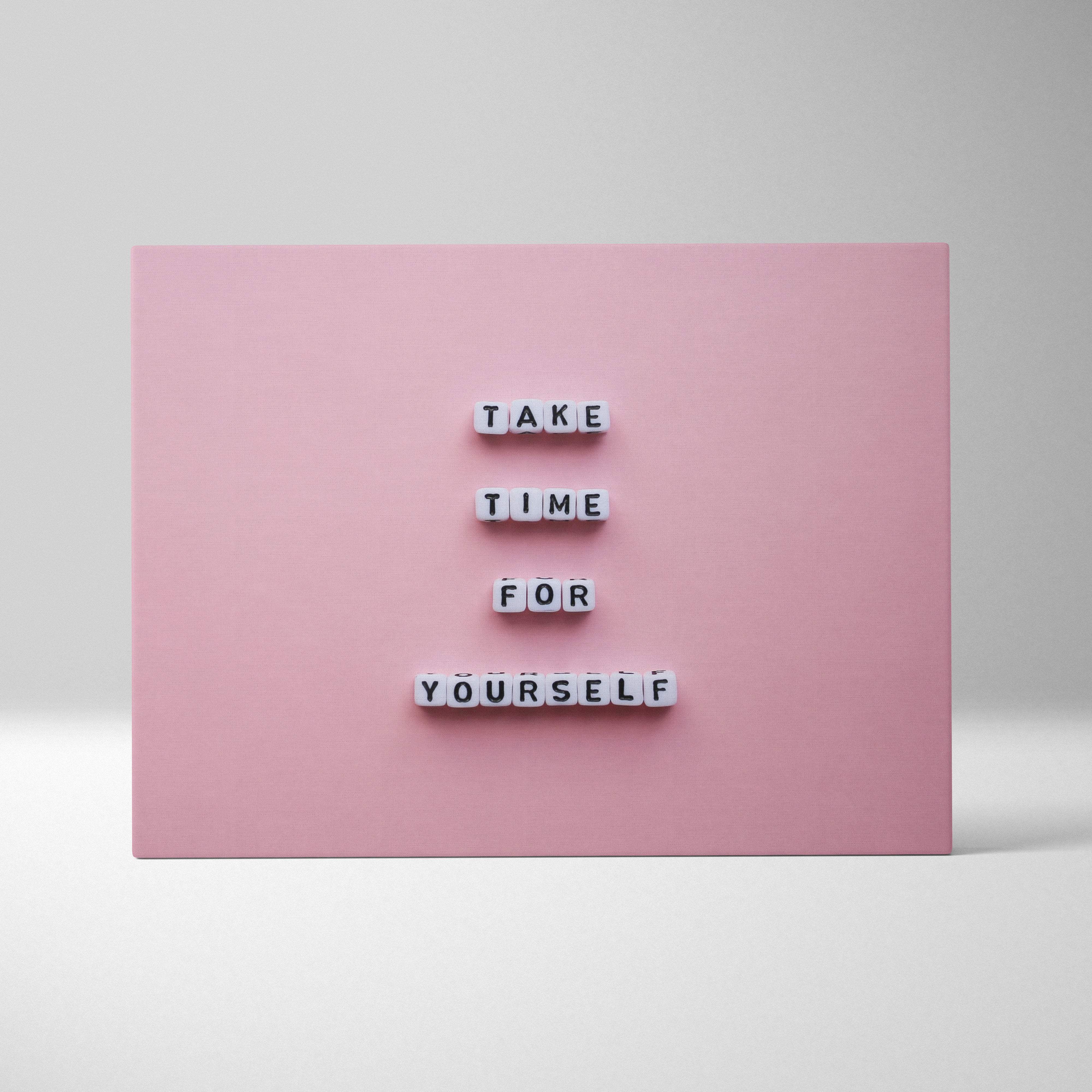 Pink rectangular canvas wall art with white letter tiles spelling take time for yourself motivational minimalist decor
