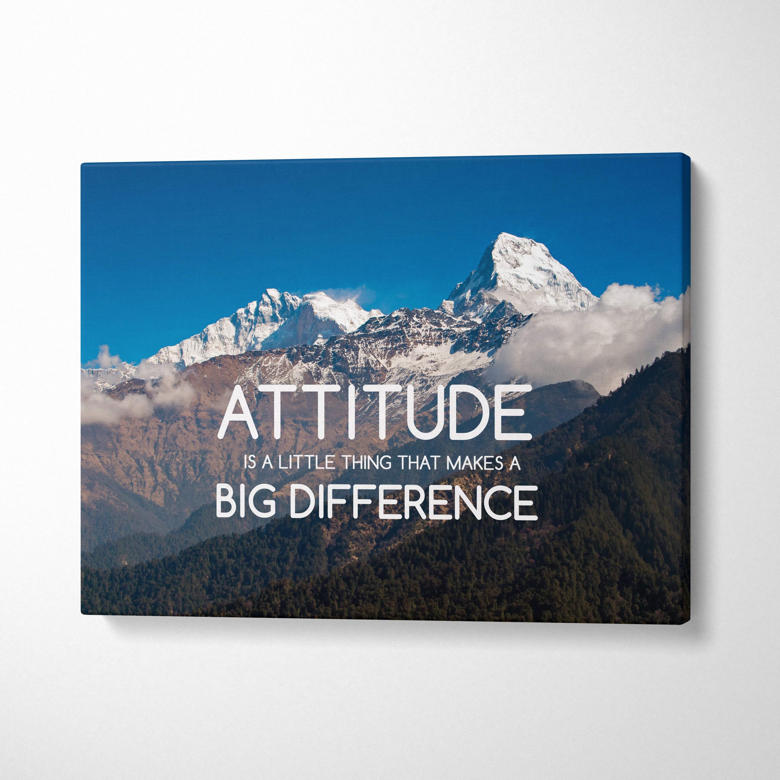 Motivational mountain canvas wall art featuring a snow-capped range and attitude is a little thing quote in white letters