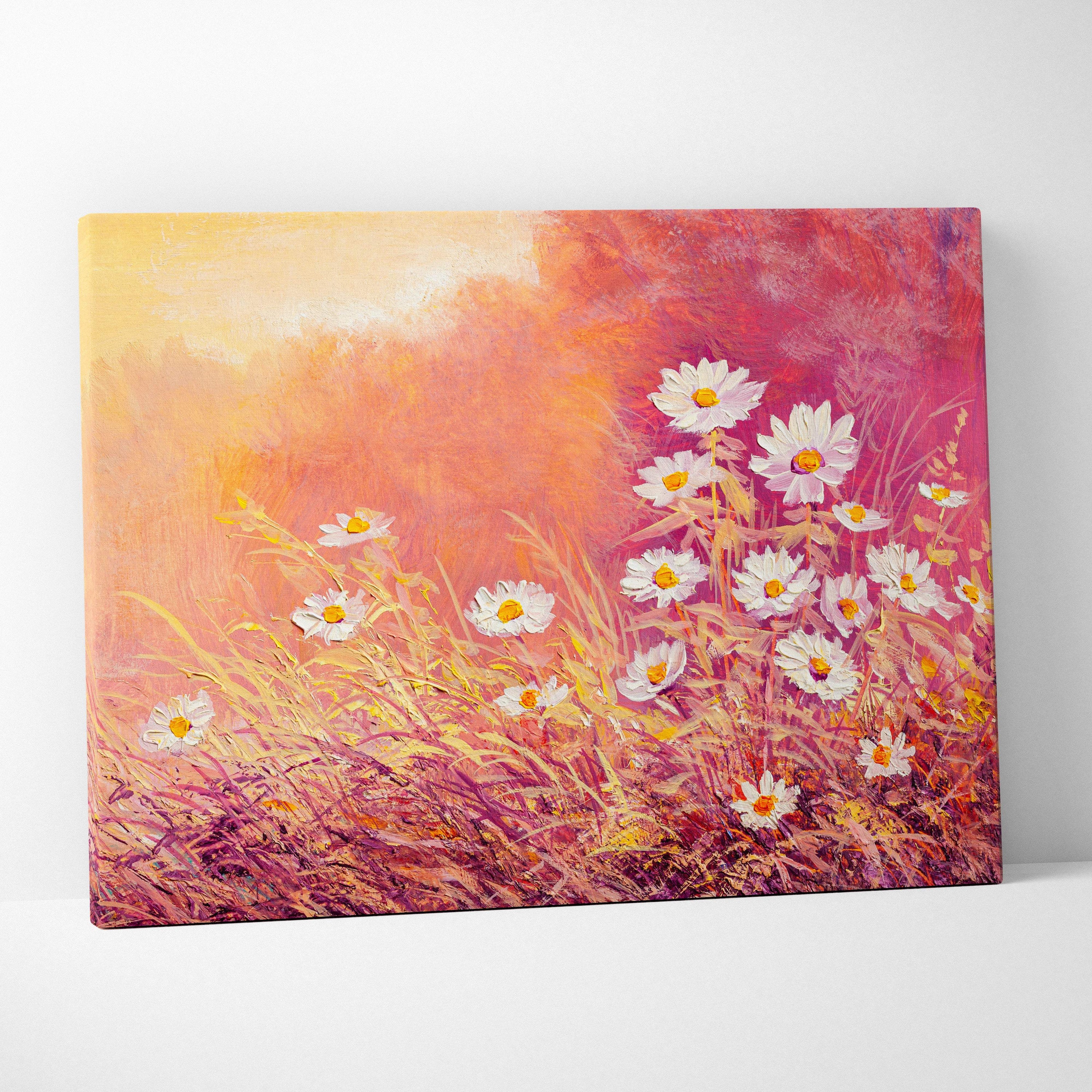 A vibrant canvas print of sunlit wild daisies with yellow centers against a warm orange and pink pastel backdrop