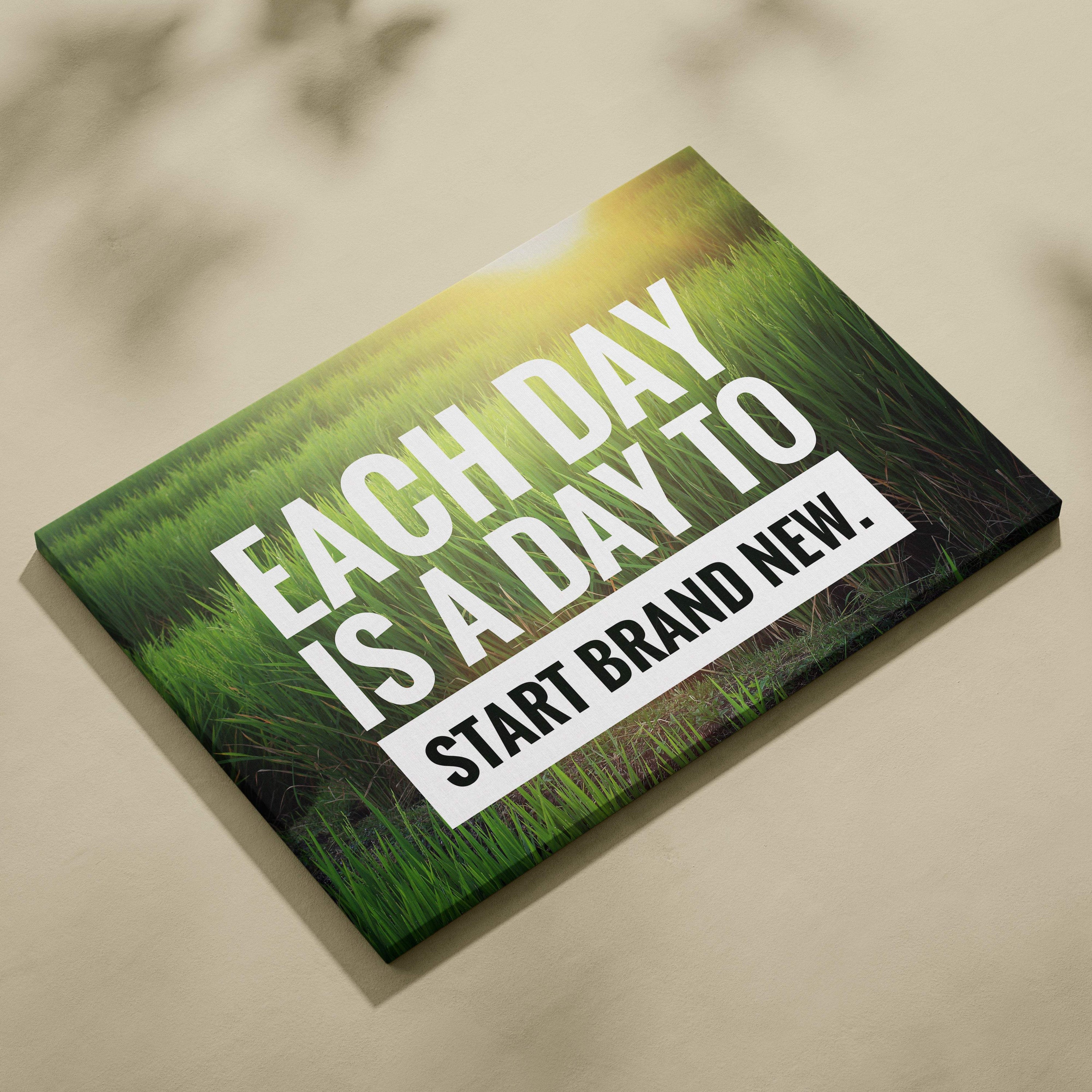 Motivational nature canvas wall art with a vibrant green grass field and inspirational each day is a day to start brand new quote