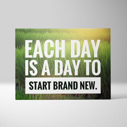 Rectangular canvas print with bold white and black text on a vibrant green grass field with golden sunlight motivational decor