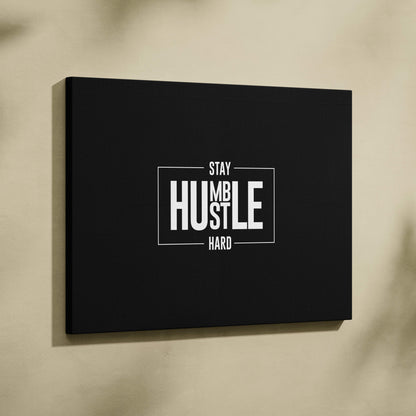 Black canvas wall art with white motivational stay humble hustle hard text in a modern font for minimalist office decor