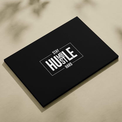 Black canvas print featuring stay humble hustle hard white text in bold modern font with minimalist rectangular border