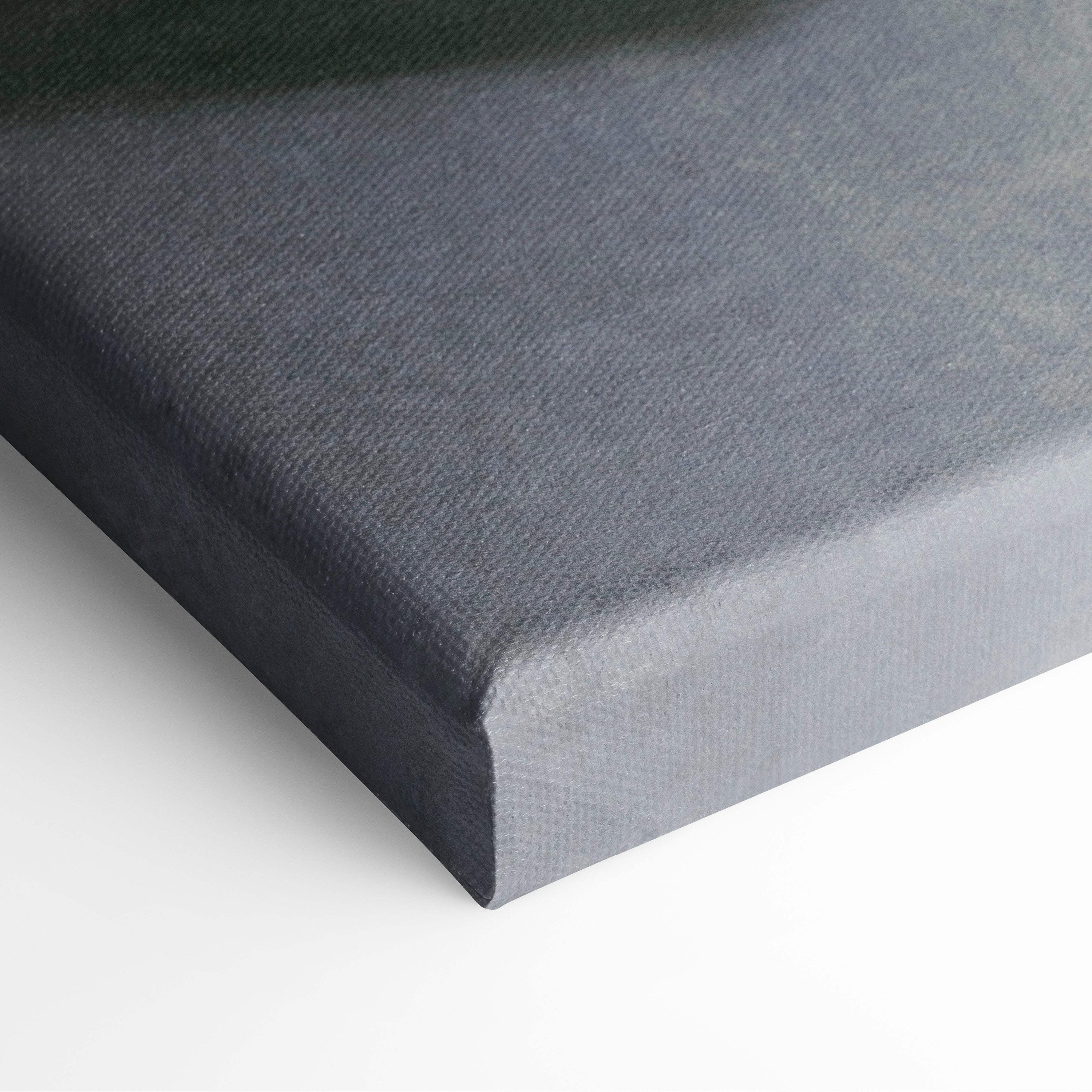 Dark gray canvas wall art with textured woven surface and raised edges featuring moody surreal figure print
