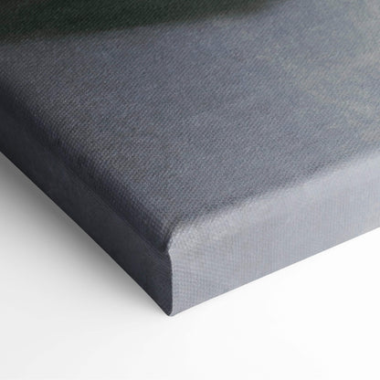 Dark gray canvas wall art with textured woven surface and raised edges featuring moody surreal figure print