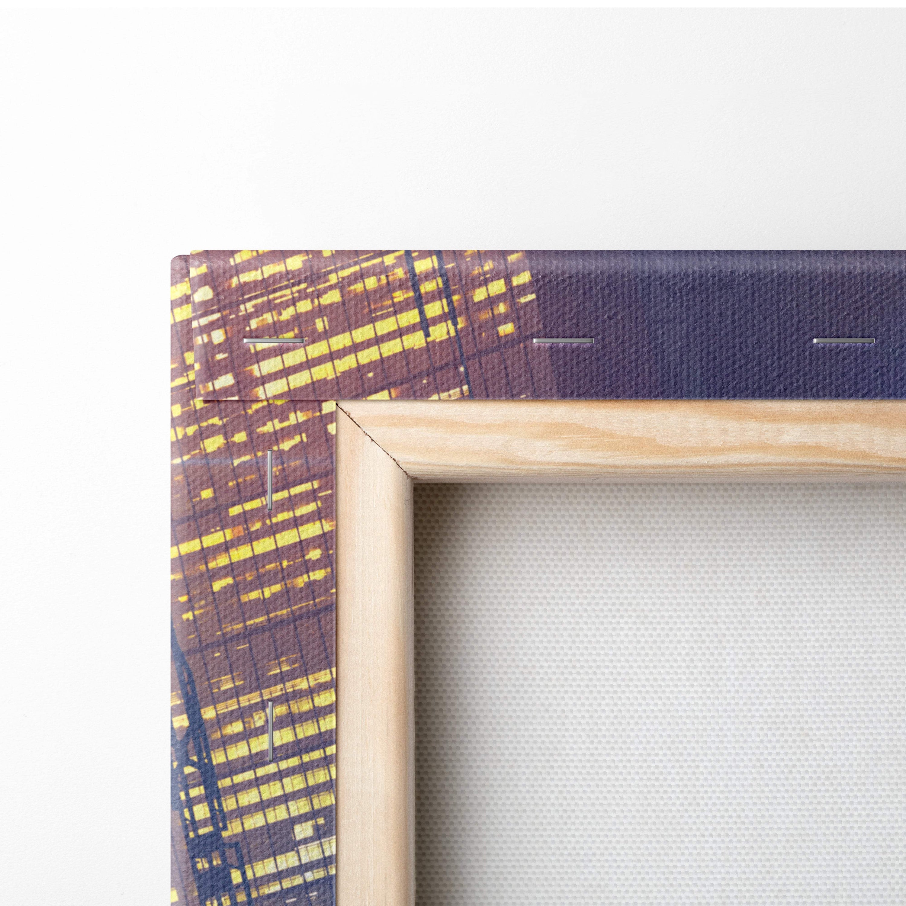 Light-colored wooden frame holding cyberpunk biker canvas wall art with yellow brown cityscape on dark blue background
