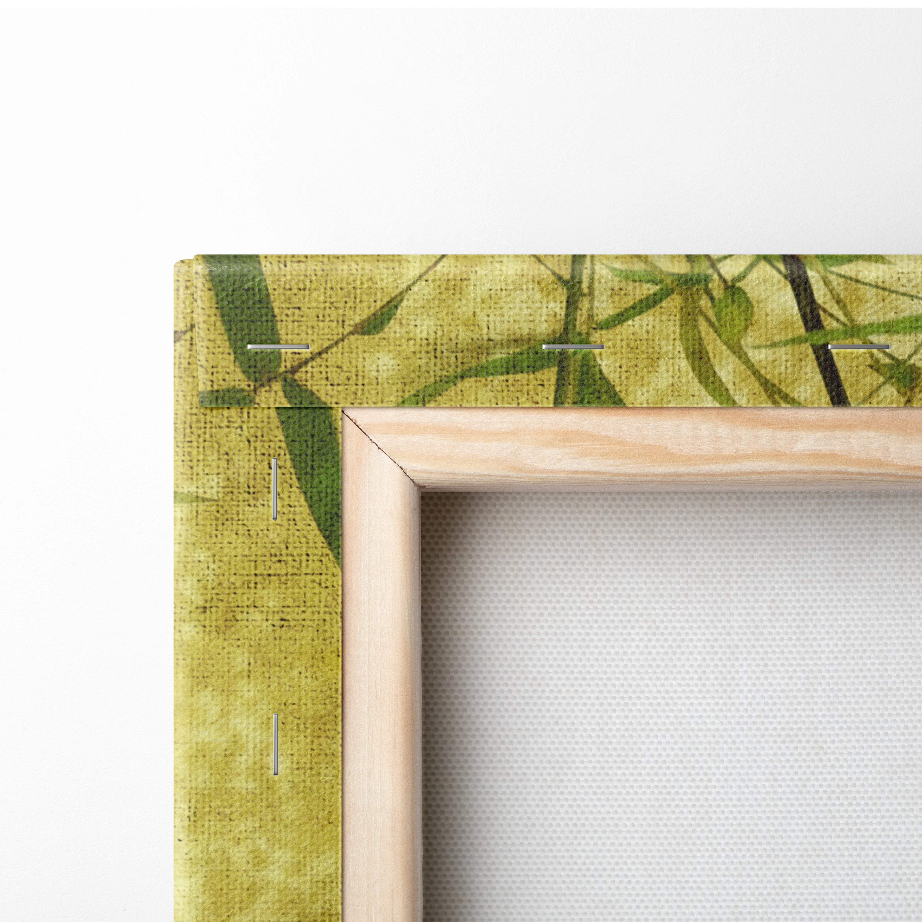 A light wood-framed canvas print with green bamboo leaf pattern on textured yellowish-green fabric for zen decor