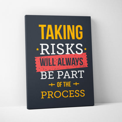 Dark navy canvas print with bold yellow and white text and red banner reading taking risks will always be part of the process motivational wall art for office or home